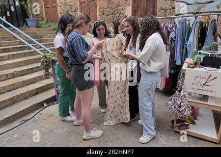 Beirut, Lebanon. 19th May, 2023. People look at a dress at a flea market exhibition at St. Nicholas Stairs in Beirut, Lebanon, on May 19, 2023. The flea market exhibition is held here from May 19 to May 21. Credit: Dana Halawi/Xinhua/Alamy Live News Stock Photo