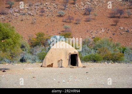 Namibia; Kunene Region; northern Namibia; Kaokoveld; Himba Village on the Kunene River ; typical mud hut in the form of an igloo Stock Photo