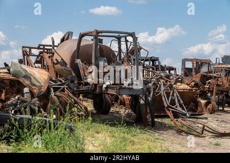 View of the destructions of agricultural equipment of Farm Pershe Travnia of village Velyka Oleksandrivka of Kherson region seen after liberation from Russian invasion. The farm was producing grain (wheat, barley, sunflower), meat (pork), and other products; with 100 employees and more than 3,000 hectares of fields, more than 1200 pigs. The farm was completely destroyed, all equipment, harvest from 2021, fertilizer, all buildings including storages for grain and places where pigs were kept and fed. After bombing pigs were either burned alive, some in panic jumped into the well. Serhiy Kosyuk e Stock Photo