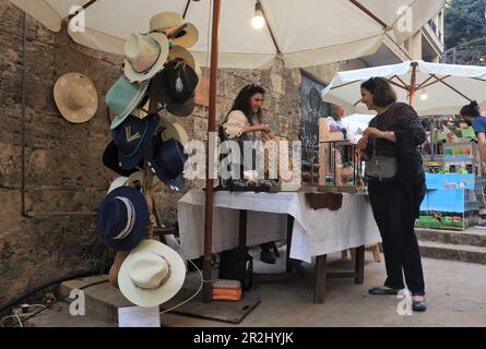 Beirut, Lebanon. 19th May, 2023. A woman visits an accessories booth in a flea market exhibition at St. Nicolas Stairs in Beirut, Lebanon, on May 19, 2023. The flea market exhibition is held here from May 19 to May 21. Credit: Liu Zongya/Xinhua/Alamy Live News Stock Photo