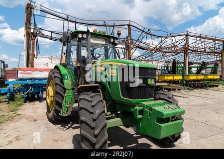 May 19, 2023, Kherson region, Ukraine: New agricultural equipment loaned free by The Howard G. Buffett Foundation to Farm Pershe Travnia of village Velyka Oleksandrivka of Kherson region seen after liberation from Russian invasion. The farm was producing grain (wheat, barley, sunflower), meat (pork), and other products; with 100 employees and more than 3,000 hectares of fields, more than 1200 pigs. The farm was completely destroyed, all equipment, harvest from 2021, fertilizer, all buildings including storages for grain and places where pigs were kept and fed. After bombing pigs were either bu Stock Photo