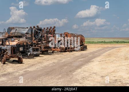 May 19, 2023, Kherson region, Ukraine: View of the destructions of agricultural equipment of Farm Pershe Travnia of village Velyka Oleksandrivka of Kherson region seen after liberation from Russian invasion. The farm was producing grain (wheat, barley, sunflower), meat (pork), and other products; with 100 employees and more than 3,000 hectares of fields, more than 1200 pigs. The farm was completely destroyed, all equipment, harvest from 2021, fertilizer, all buildings including storages for grain and places where pigs were kept and fed. After bombing pigs were either burned alive, some in pani Stock Photo