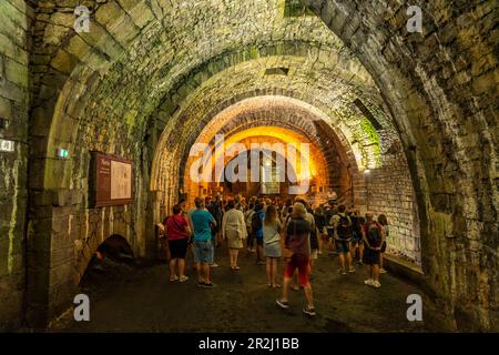 Tourists on a guided tour through the tunnels of the Great Saltworks of Salins-les-Bains, UNESCO World Heritage Site in Salins-les-Bains, Bourgogne-Fr Stock Photo