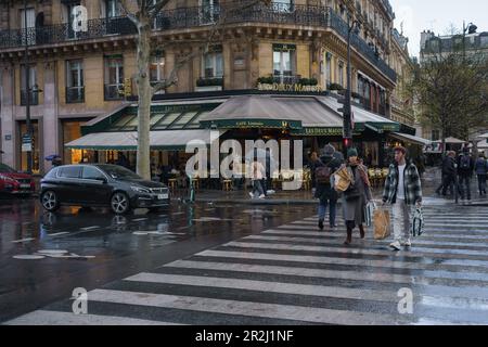 Restaurant Les Deux Magots and pedestrian crossing on boulevard Saint Germain in Paris, France. March 24, 2023. Stock Photo