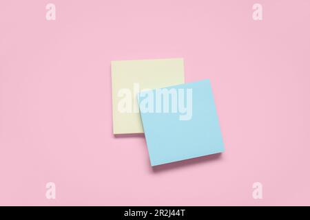 Sticky notes on pale pink background Stock Photo