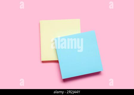 Sticky notes on pale pink background Stock Photo