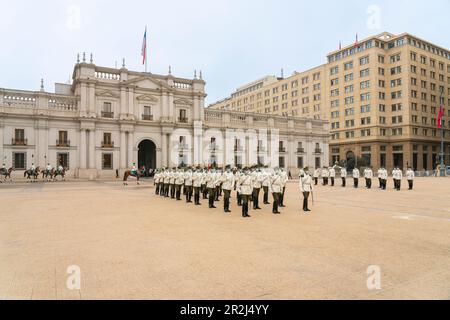 Policemen performing changing of guards ceremony in front of La Moneda Palace, Santiago, Santiago Metropolitan Region, Chile, South America Stock Photo