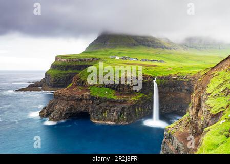 The iconic waterfall of Mulafossur, Gasadalur, Vagar, Faroe islands, Denmark, Northern Europe, Europe Stock Photo