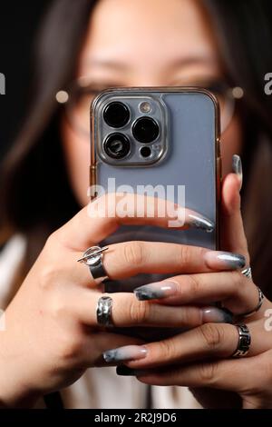 Female hand with smartphones close up, young woman using mobile phone, Instagram, Tik Tok and Facebook, France, Europe Stock Photo