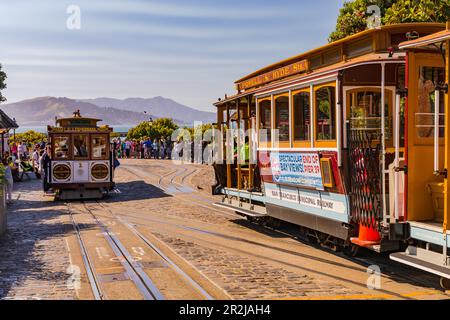 Two cable cars and a crowd boarding at Hyde Street Station, San Francisco, California, USA Stock Photo