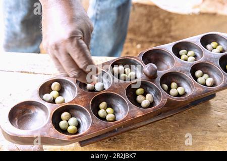 Board game Awale by the carvers of Ahwiaa north of Kumasi in the Ashanti region of central Ghana in West Africa Stock Photo