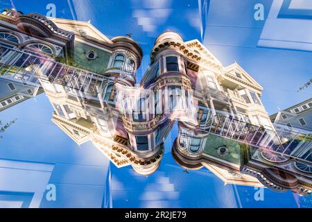 Double exposure of a Victorian style colorful wooden residential building on Steiner street in San Francisco, California. These houses are known as th Stock Photo