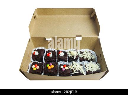 chocolate brownies in a paper box ready to take home. chocolate brownies isolated on white background Stock Photo
