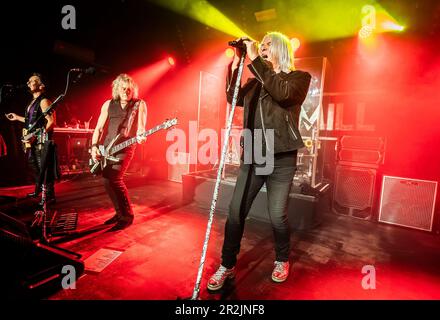 Def Leppard lead singer Joe Elliott (right) with guitarist Vivian Campbell (left) and bassist Rick Savage (centre) perform on stage during their 'One Night Only' gig at the Leadmill in Sheffield. Picture date: Friday May 19, 2023. Stock Photo