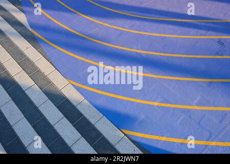 Fragment of blue high technology rubber recycled surface for walking and jogging path next to pedestrian area.  Stock Photo