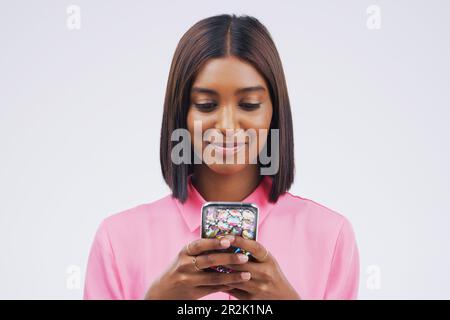 Contact, smile and Indian woman with a phone, typing and connection against a studio white background. Female person, girl and model with a cellphone Stock Photo