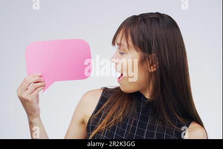 Surprised, woman with speech bubble and against a white background. Communication or conversation, social media or announcement and person with wow or Stock Photo