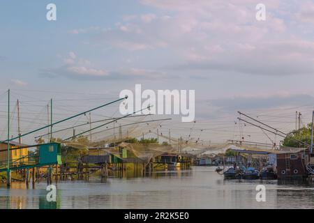 Comacchio, Porto Garibaldi, Canale Torre Rossa with fishermen's huts and outrigger nets Stock Photo