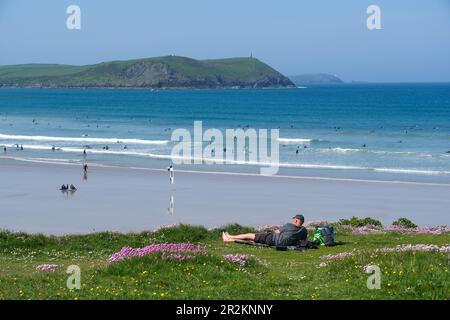 Polzeath, Cornwall, UK. 20th May 2023. UK Weather. With the temperature at 18 degrees C this morning and due to rise, it was a lovely morning on the coast and beach at Polzeath. Surfers were making the most of the conditions. Credit Simon Maycock / Alamy Live News. Stock Photo
