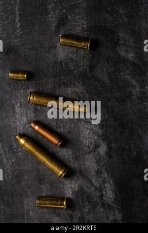 Empty bullet cartridges lying on the black background. Stock Photo