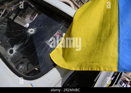 Munich, Germany. 20th May, 2023. Bullet holes can be seen in the windshield of a destroyed Ukrainian ambulance during a rally on Marienplatz against the war in Ukraine. Afterwards, the ambulance will be exhibited at the Rindermarkt from May 22 to 27 and will then go on tour to various cities in Europe. Credit: Felix Hörhager/dpa/Alamy Live News Stock Photo