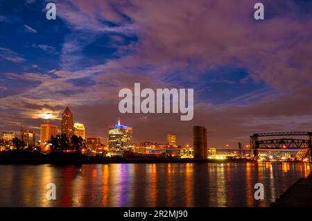 Moonrise over downtown Cleveland, Ohio, seen from the mouth of the Cuyahoga River Stock Photo