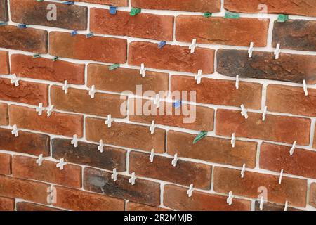 Decorative bricks with tile leveling system on wall Stock Photo
