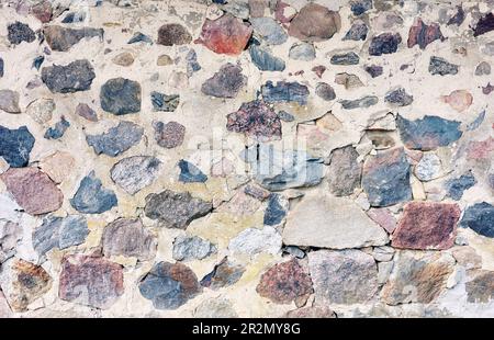 Old rough rock wall, abstract background or texture. Stock Photo