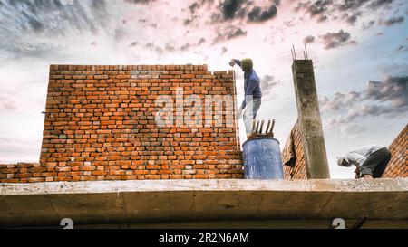 Man checks the accuracy of the walls using a measuring tape. Bricklaying Basics Masonry Techniques. Stock Photo