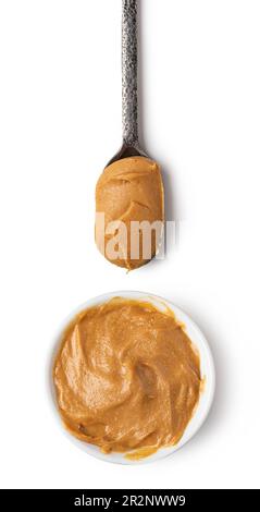 Premium Photo  Glass jar and spoon full of peanut butter isolated on white