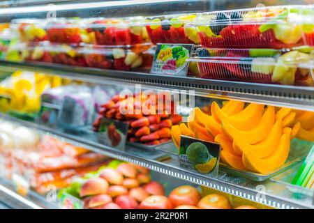 SINGAPORE - MAR 3, 2020: Packages with fresh fruits displayed in a commercial refrigerator Stock Photo