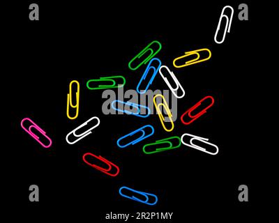 Multi-colored staples on a black background Stock Photo