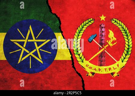 Ethiopia and Tigray People’s Liberation Front (TPLF) flags on wall with crack. Ethiopia and TPLF conflict. Tigray war. Ethiopia vs TPLF Stock Photo