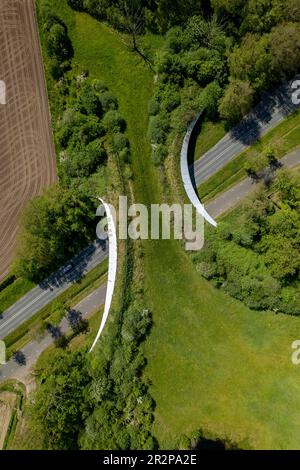 Aerial of road traversed by wildlife crossing forming a safe natural ...