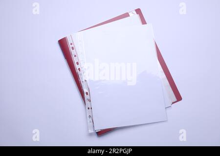 File folder with punched pockets and paper sheets isolated on white, top view Stock Photo