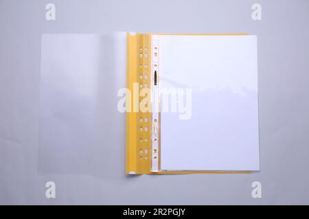 File folder with punched pockets and paper sheets on light grey background, top view Stock Photo