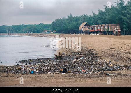 Polluted beach. The problem of global ocean pollution. A pile of plastic debris is scattered on the shores of the Indian Ocean on the island of Bali Stock Photo