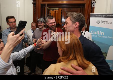 Michael Collins (right) from People Before Profit, who has won the last seat, at Belfast City Hall during the Northern Ireland council elections. Picture date: Saturday May 20, 2023. Stock Photo