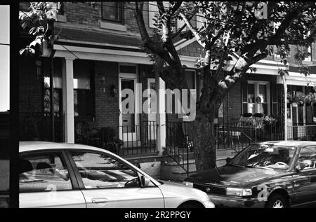 West Queen Lane monochrome houses and cars in Philadelphia, Pennsylvania, USA, taken with a old Leica with a Summitar lens. Stock Photo