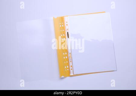 File folder with punched pockets and paper sheets isolated on white, top view Stock Photo