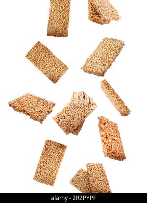 Many puffed rice bars (kozinaki) falling on white background Stock Photo