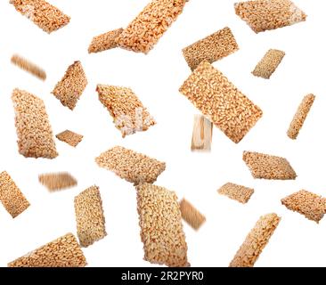 Many puffed rice bars (kozinaki) falling on white background Stock Photo