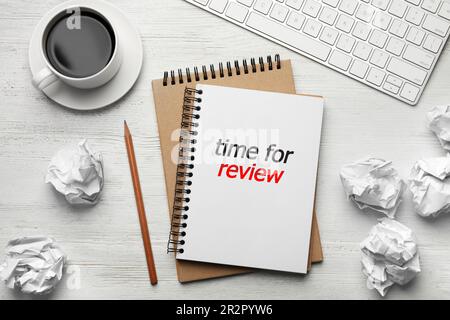 Notepad with text Time For Review, pencil, computer keyboard, cup of coffee and crumpled paper balls on white wooden table, flat lay Stock Photo