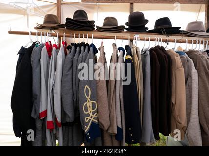 Resaca, Georgia, USA. 20th May, 2023. Civil War re-enactors, their families and history buffs brave the rain for the annual re-enactment of the Battle of Resaca in North Georgia. Pictured: Period uniforms and civilian clothing for sale at a sutler's tent. (Credit Image: © Robin Rayne/ZUMA Press Wire) EDITORIAL USAGE ONLY! Not for Commercial USAGE! Stock Photo