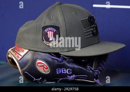 A Seattle Mariners Salute to Service cap rests on a glove in the