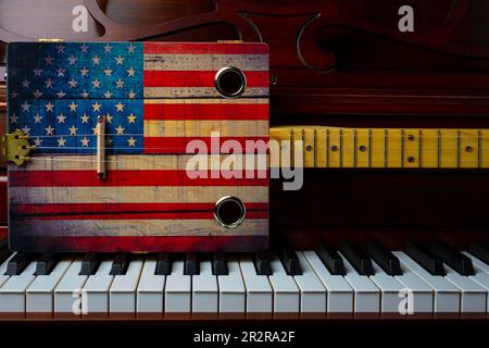 Cigar Box American Flag Guitar On Piano Keys Still Life Stock Photo