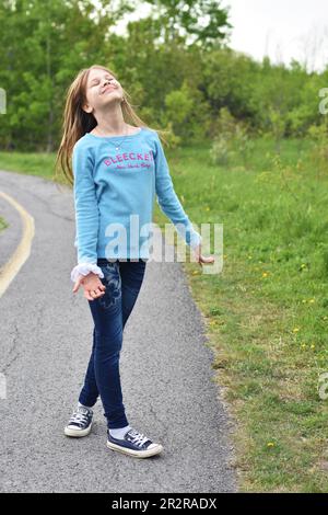 Beautiful young long hair girl in causal clothes posing outdoors Stock Photo