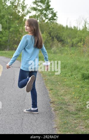 Beautiful young long hair girl in causal clothes posing outdoors Stock Photo