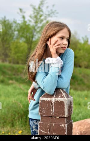 Beautiful young long hair girl in causal clothes posing outdoors Stock Photo