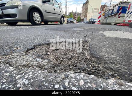 Hamburg, Germany. 19th May, 2023. A pothole is seen on a street in the city center. In Hamburg, there are signs on 45 streets indicating considerable road damage - some of which has been going on for years. As a result, accidents with injuries occur time and again. By the end of March, 23 traffic accidents had already occurred due to road damage. The CDU demands action from the red-green senate. (to dpa: 'Answer of the Senate: This year 23 accidents due to road damage'. Credit: Marcus Brandt/dpa/Alamy Live News Stock Photo